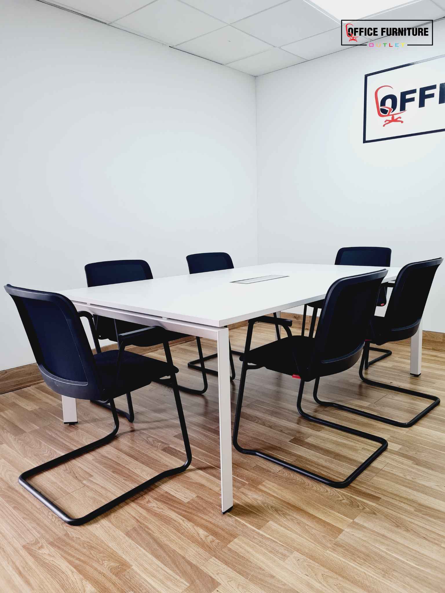 White Steelcase Meeting Table With Six Black Haworth Chairs